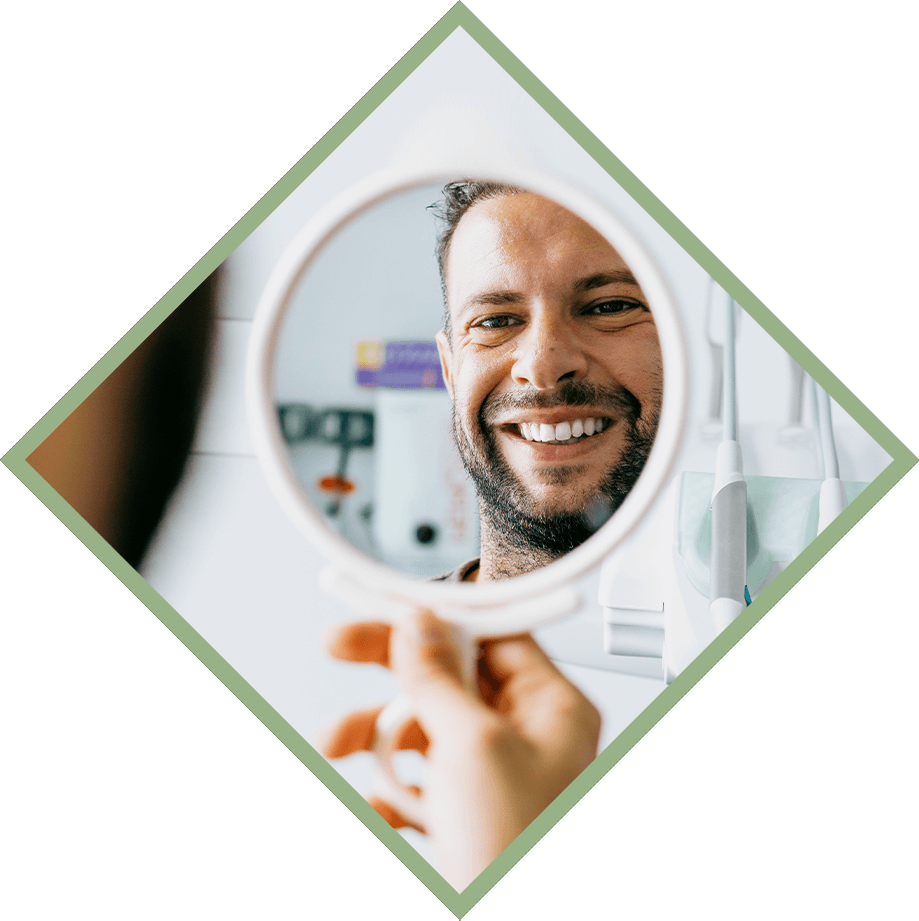 dental patient smiling in mirror