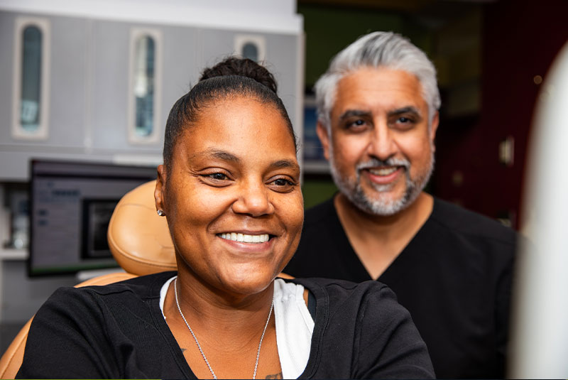patient and doctor smiling after patient's dental procedure