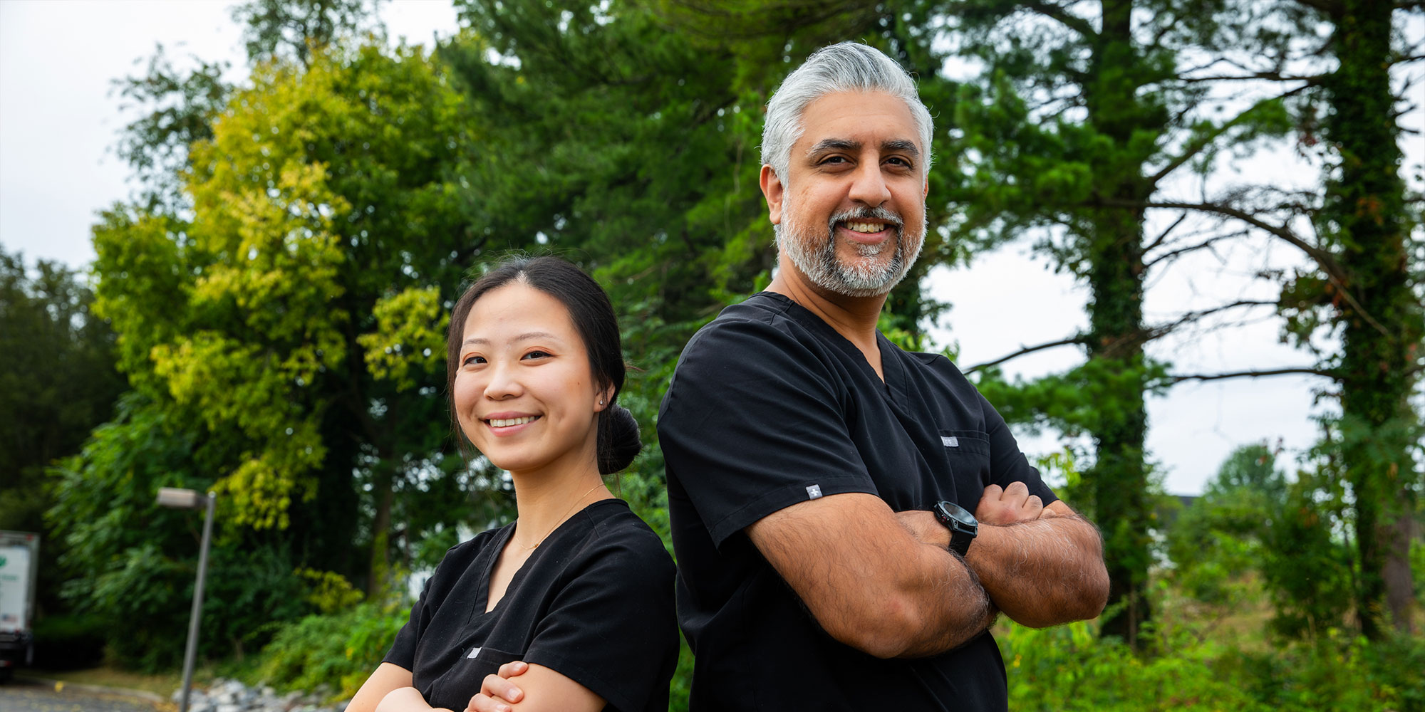doctors smiling outside of the dental practice