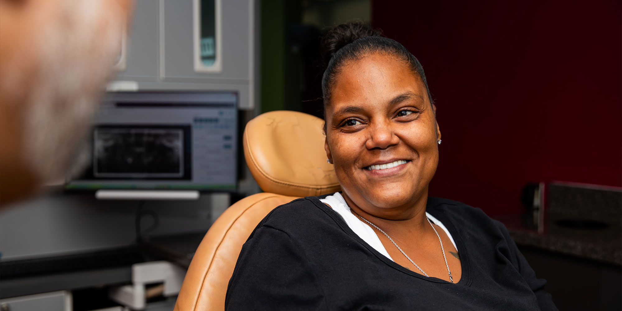 patient smiling after their dental procedure within the dental practice